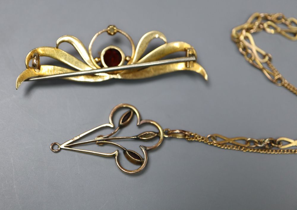 A 15ct, garnet and seed set brooch, 46mm, gross 4.3 grams and a 9ct pendant on a yellow metal chain.